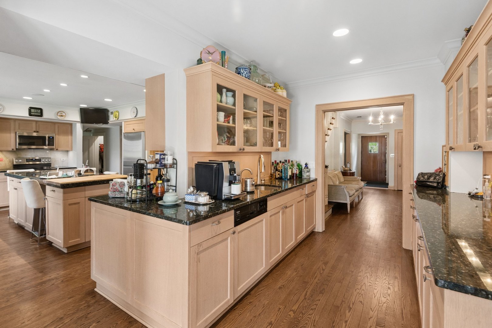 321 Woodland Road Highland Park, IL 60035 - Photo 14 of 48 a kitchen with counter top space a sink wooden floor and view living room