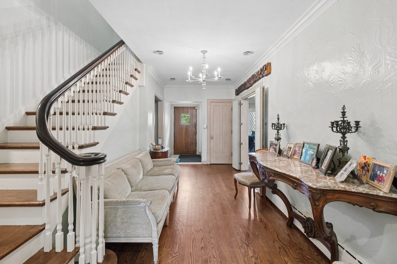 321 Woodland Road Highland Park, IL 60035 - Photo 22 of 48 a living room with furniture a fireplace and a chandelier