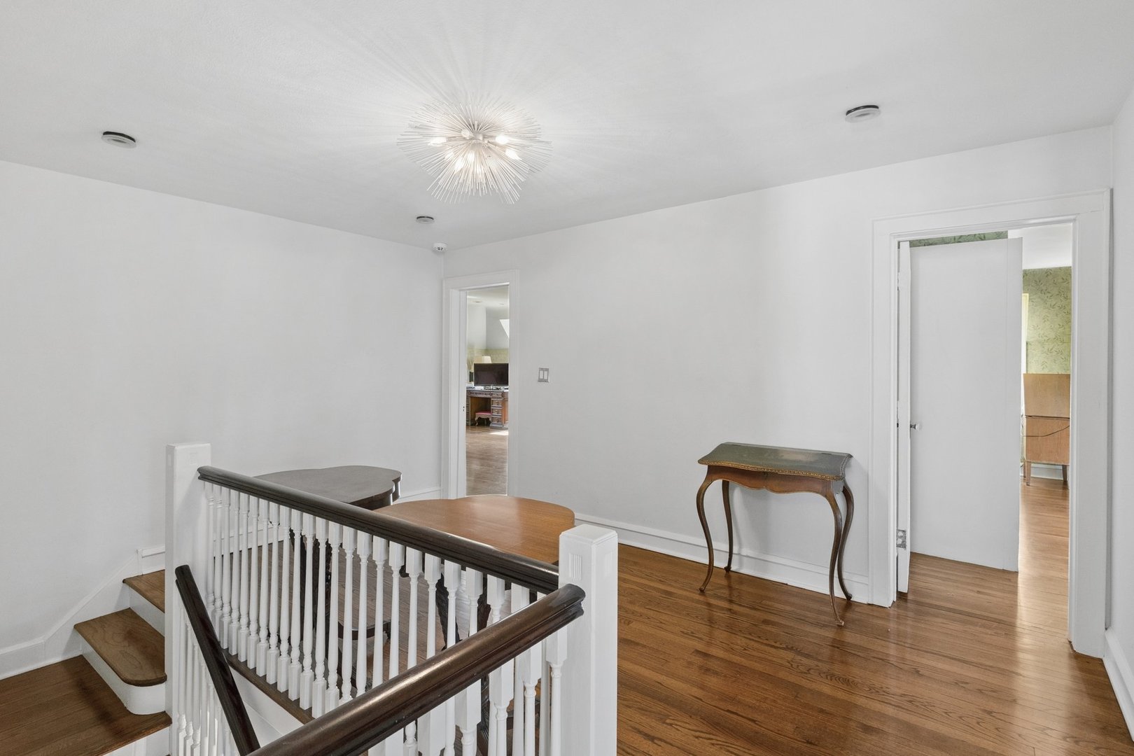 321 Woodland Road Highland Park, IL 60035 - Photo 24 of 48 a view of a hallway with wooden floor and a potted plant