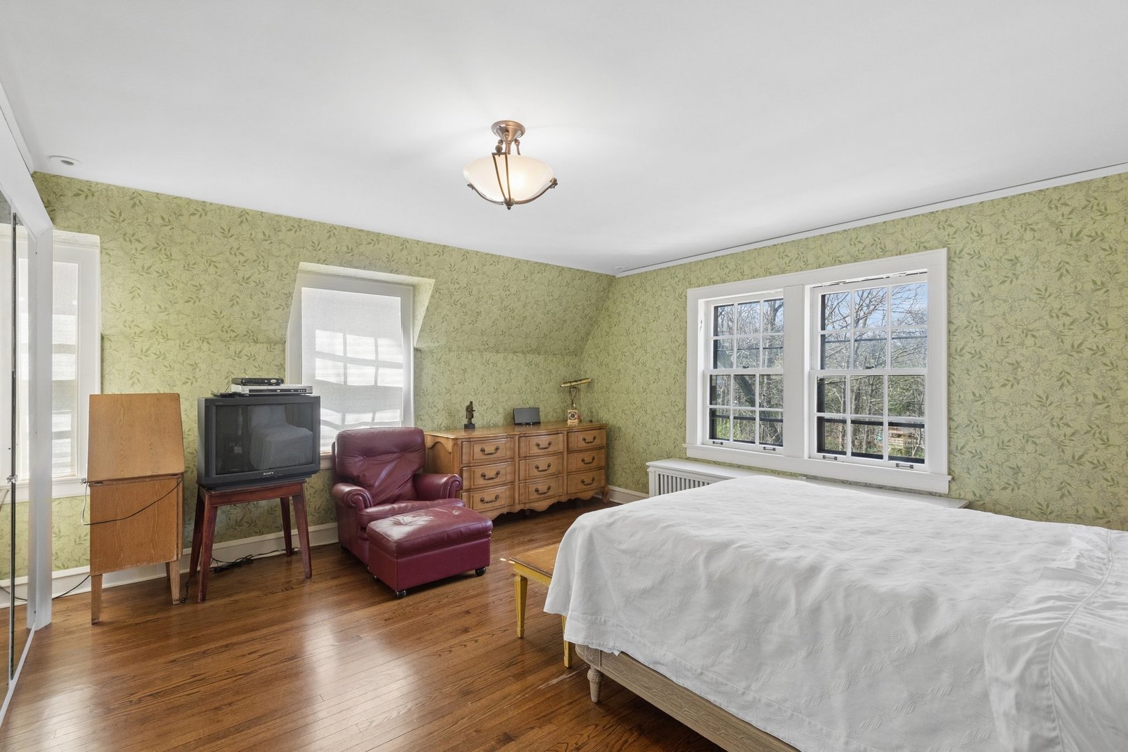 321 Woodland Road Highland Park, IL 60035 - Photo 30 of 48 a spacious bedroom with a bed and wooden floor
