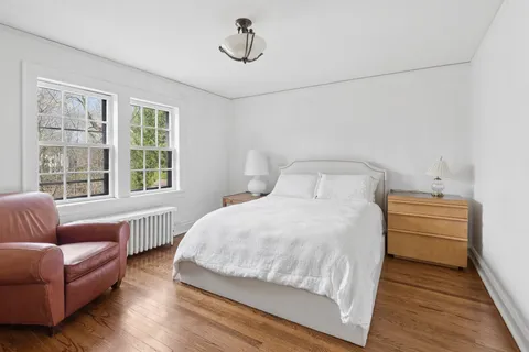 a bedroom with a bed couch and a window
