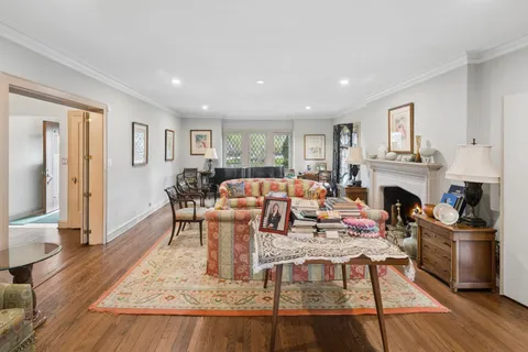 a living room with fireplace furniture and a wooden floor