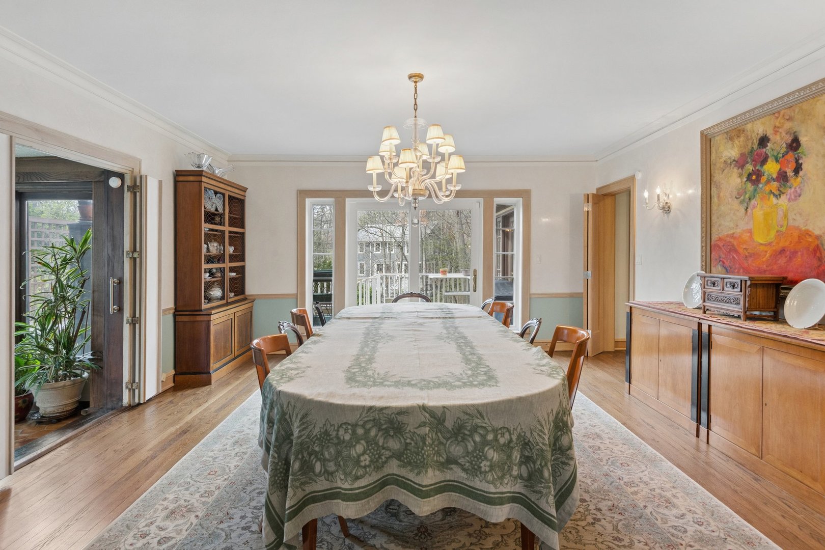 321 Woodland Road Highland Park, IL 60035 - Photo 9 of 48 a dining room with furniture a rug a potted plant and a chandelier