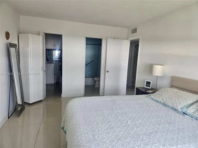 a bedroom with a bed and a mirror