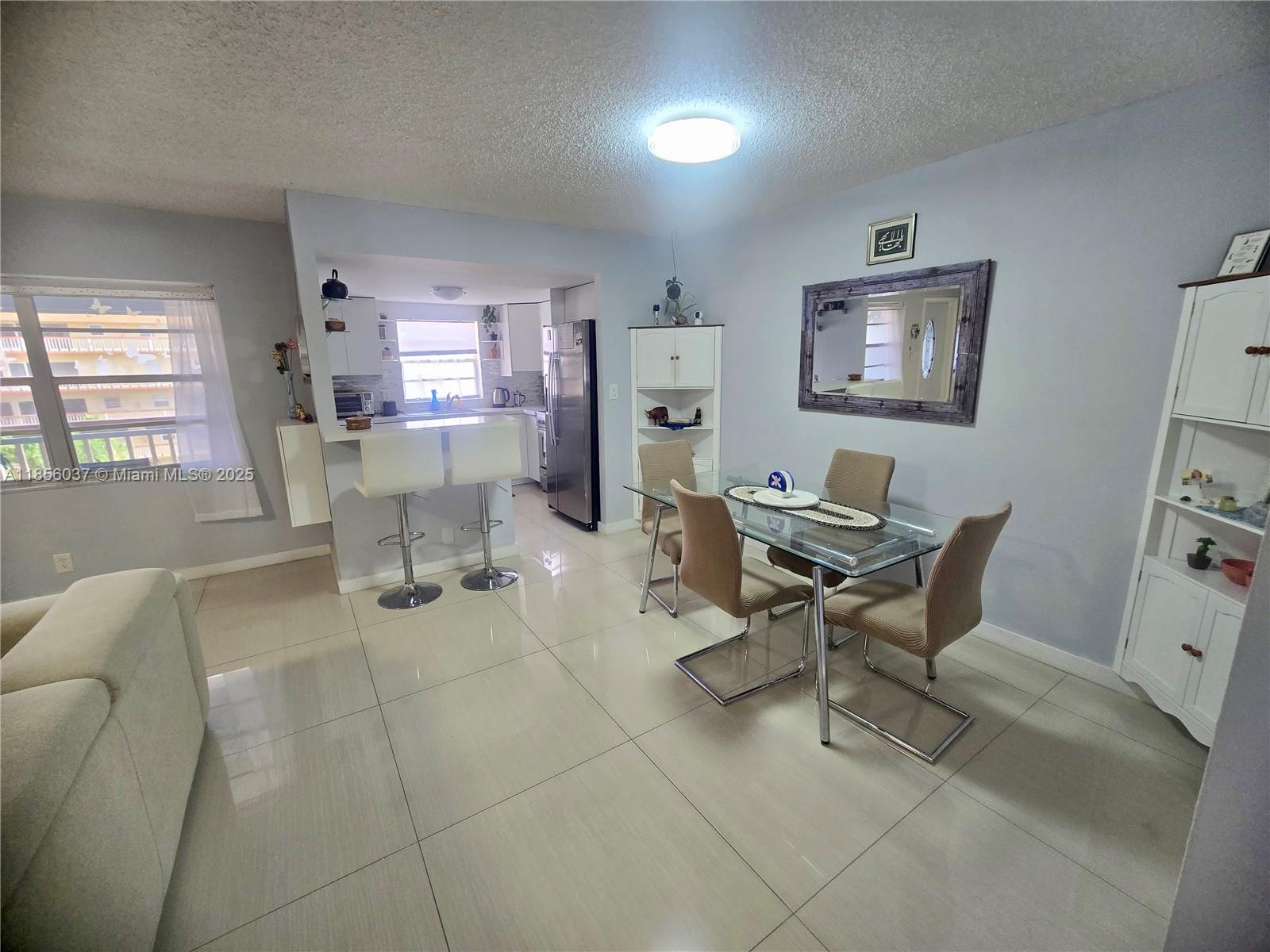 5300 Washington Street, Unit U403 Hollywood, FL 33021 - Photo 2 of 12 a work room with furniture a rug and a window