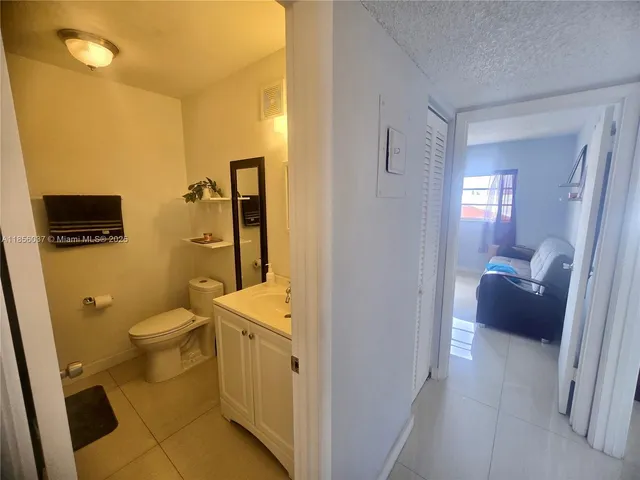 a bathroom with a granite countertop toilet sink and shower