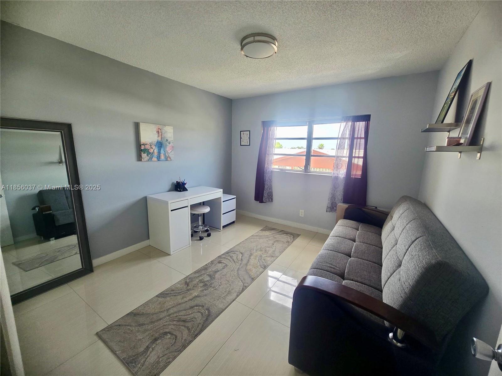 5300 Washington Street, Unit U403 Hollywood, FL 33021 - Photo 7 of 12 a living room with furniture and a flat screen tv