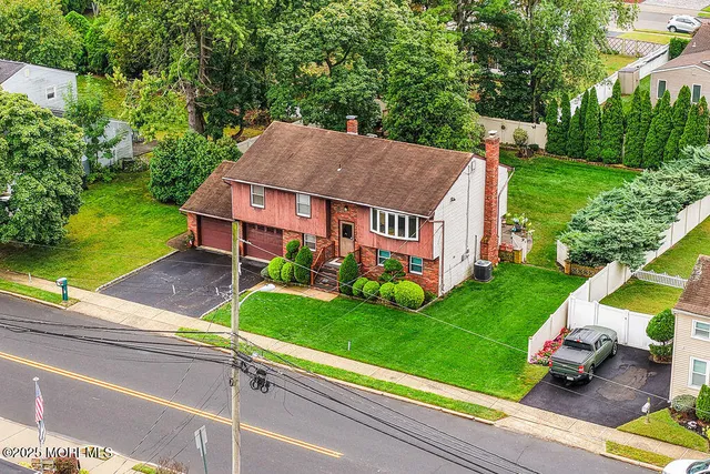 an aerial view of residential houses with outdoor space and street view