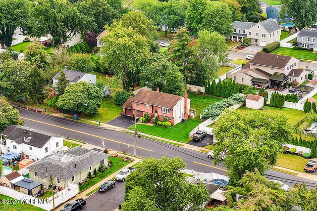 an aerial view of residential building and lake
