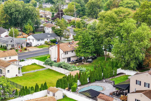 an aerial view of multiple houses with yard