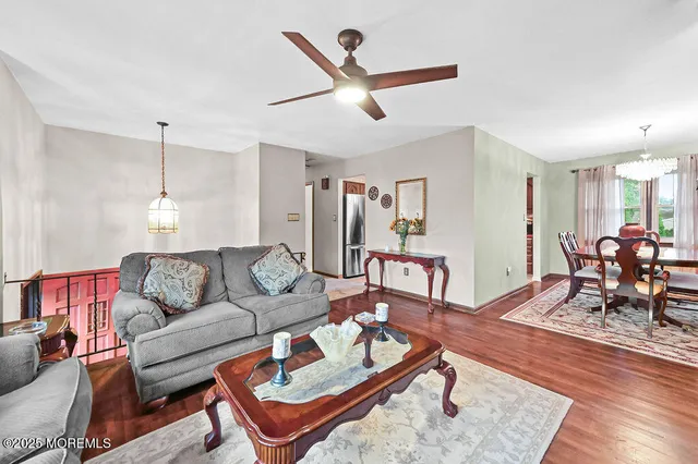a living room with furniture a rug and a chandelier