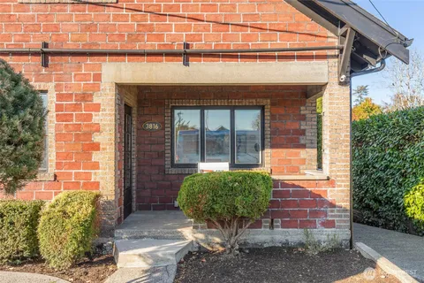 a living room with furniture and a painting on the wall