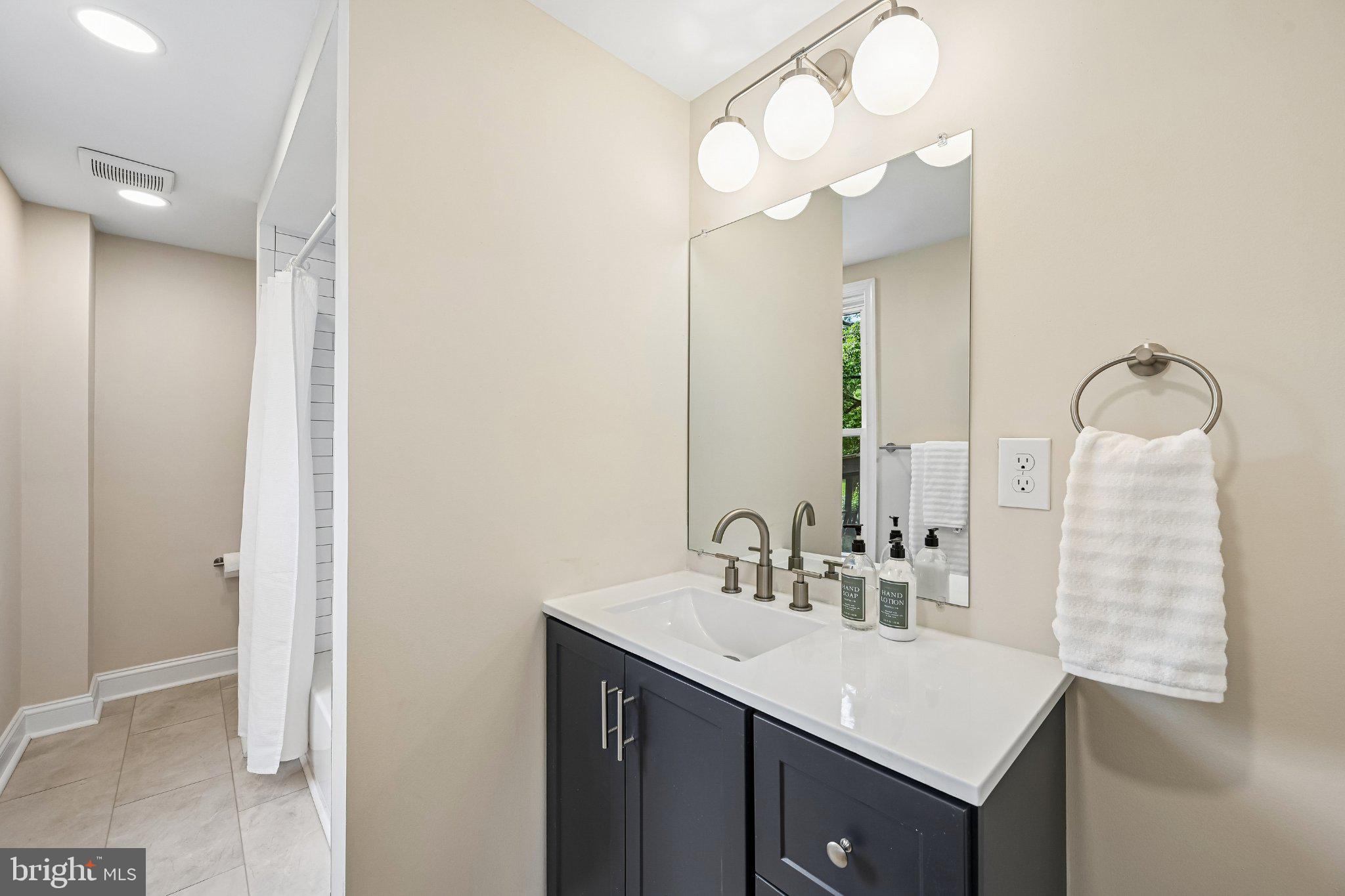 5714 Rusk Avenue Baltimore, MD 21215 - Photo 19 of 51 Modern elegance in a serene bathroom.