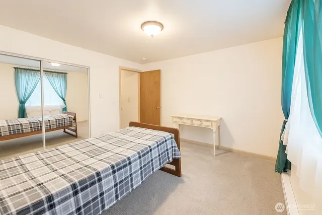 a bedroom with a bed and a couch