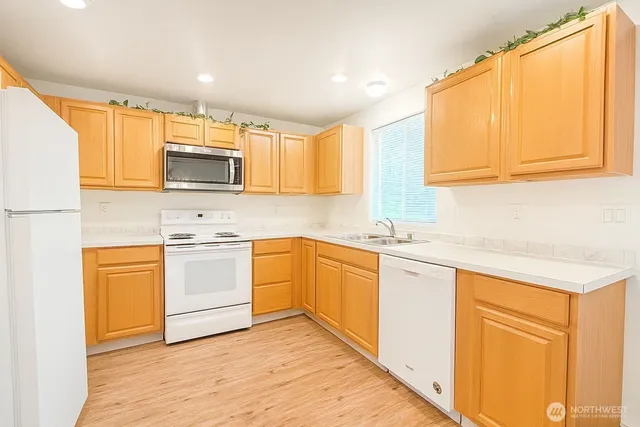 a kitchen with a refrigerator and a sink