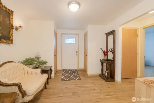 a living room with furniture and a potted plant