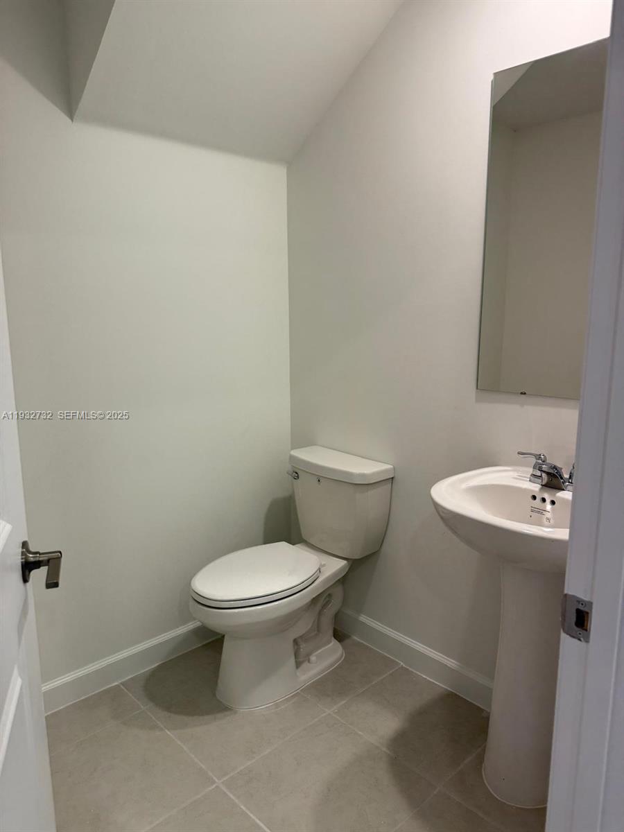 35844 Southwest 178th Court Homestead, FL 33034 - Photo 15 of 17 a white toilet sitting next to a bathroom sink