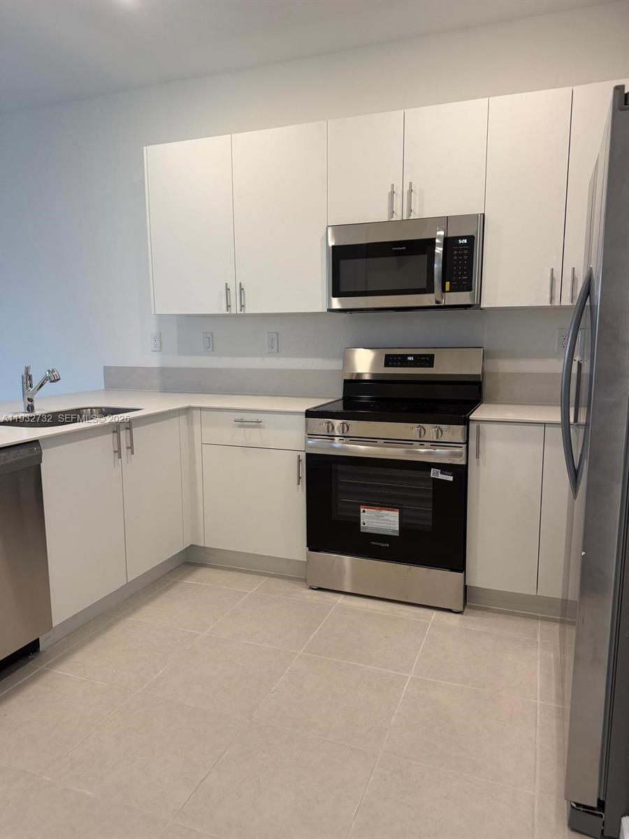 35844 Southwest 178th Court Homestead, FL 33034 - Photo 16 of 17 a kitchen with stainless steel appliances a stove a microwave and a sink