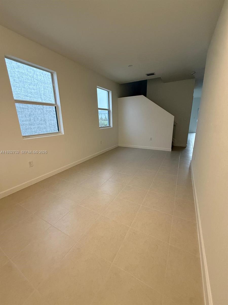35844 Southwest 178th Court Homestead, FL 33034 - Photo 3 of 17 an empty room with windows