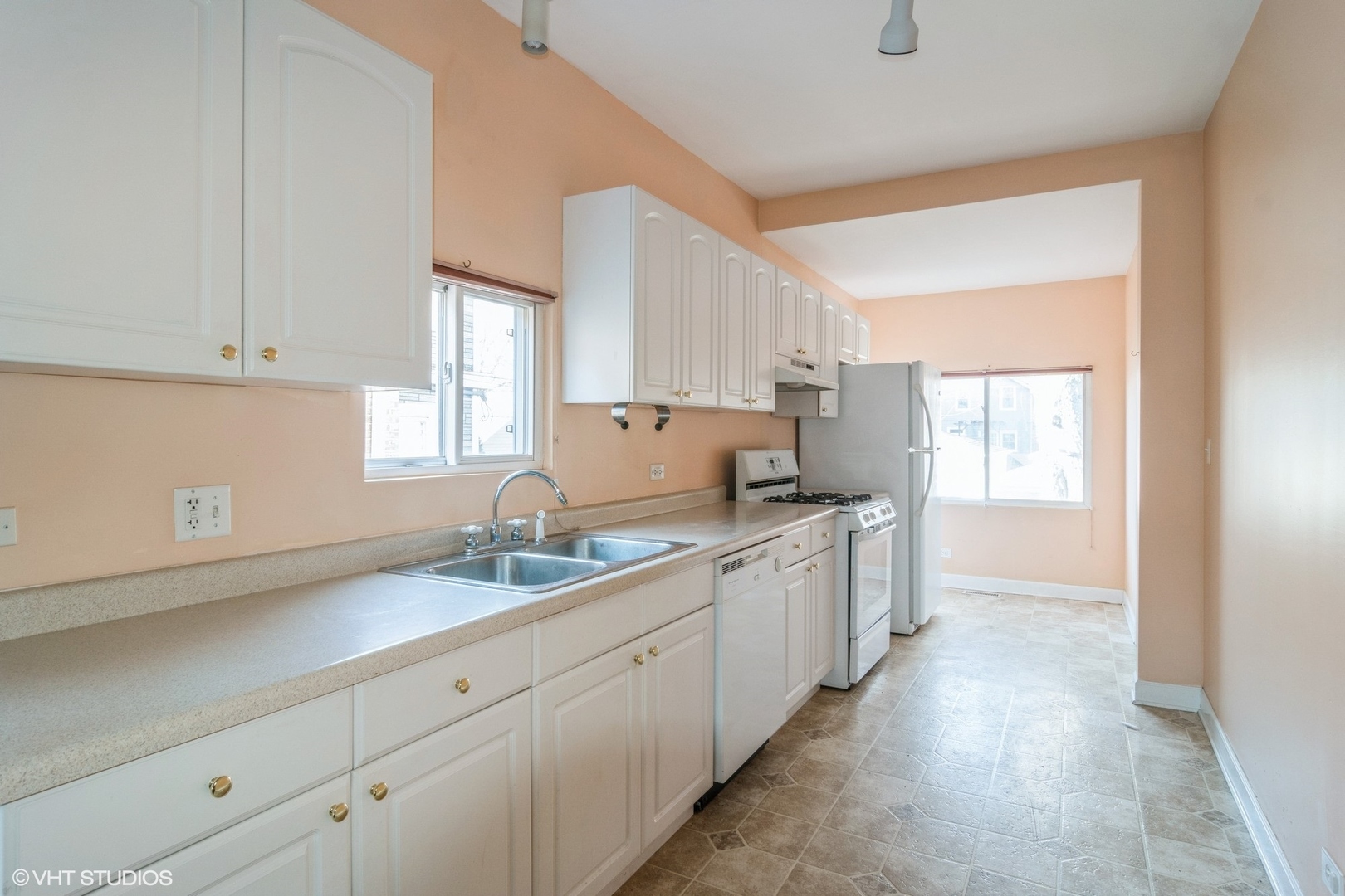 905 Thomas Avenue, Unit 1 Forest Park, IL 60130 - Photo 3 of 15 a kitchen with granite countertop white cabinets and white appliances