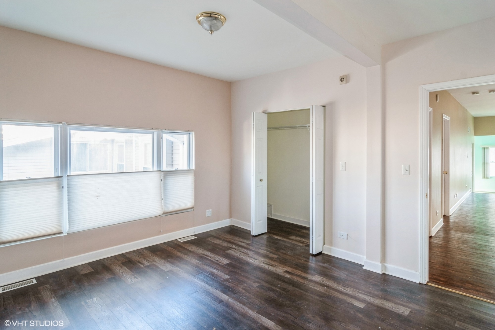 905 Thomas Avenue, Unit 1 Forest Park, IL 60130 - Photo 8 of 15 an empty room with wooden floor and windows