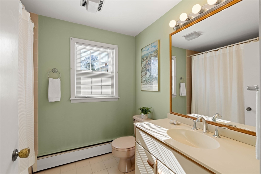 153 Jersey Street Marblehead, MA 01945 - Photo 12 of 34 a bathroom with a granite countertop toilet a sink and a mirror