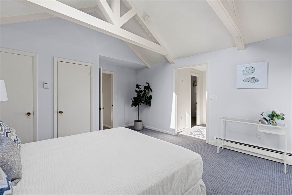 153 Jersey Street Marblehead, MA 01945 - Photo 15 of 34 a bedroom with a bed and a potted plant