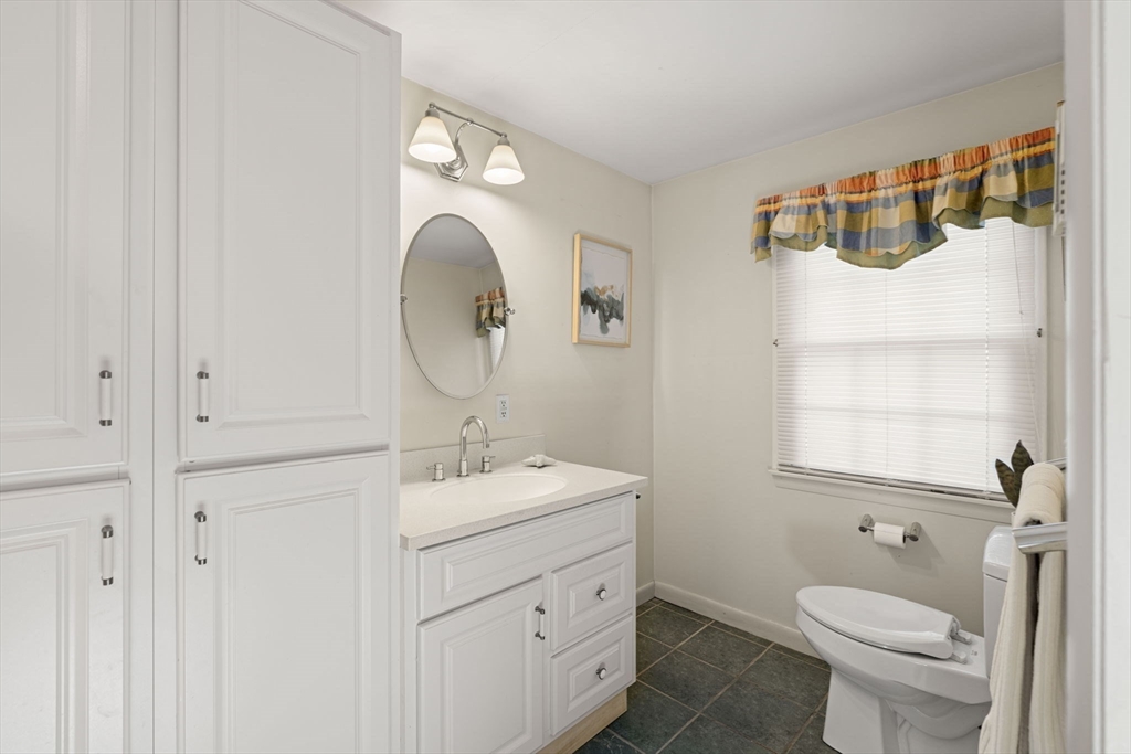 153 Jersey Street Marblehead, MA 01945 - Photo 16 of 34 a bathroom with a toilet a sink and a mirror