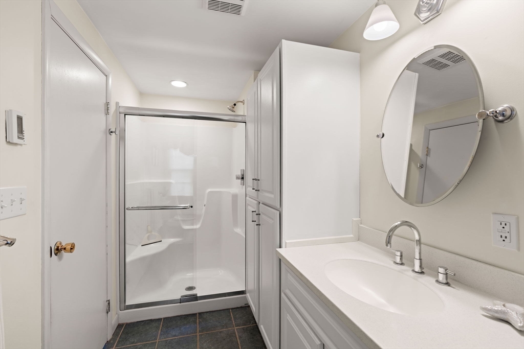 153 Jersey Street Marblehead, MA 01945 - Photo 18 of 34 a bathroom with a sink a mirror and a shower