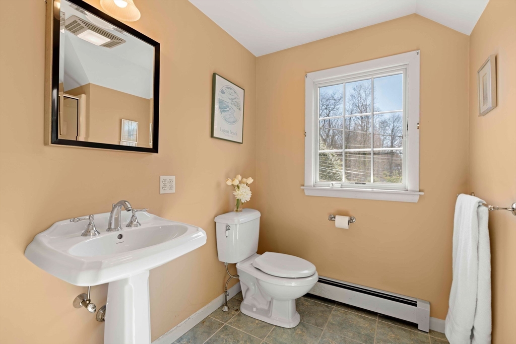 153 Jersey Street Marblehead, MA 01945 - Photo 25 of 34 a bathroom with a toilet sink and mirror