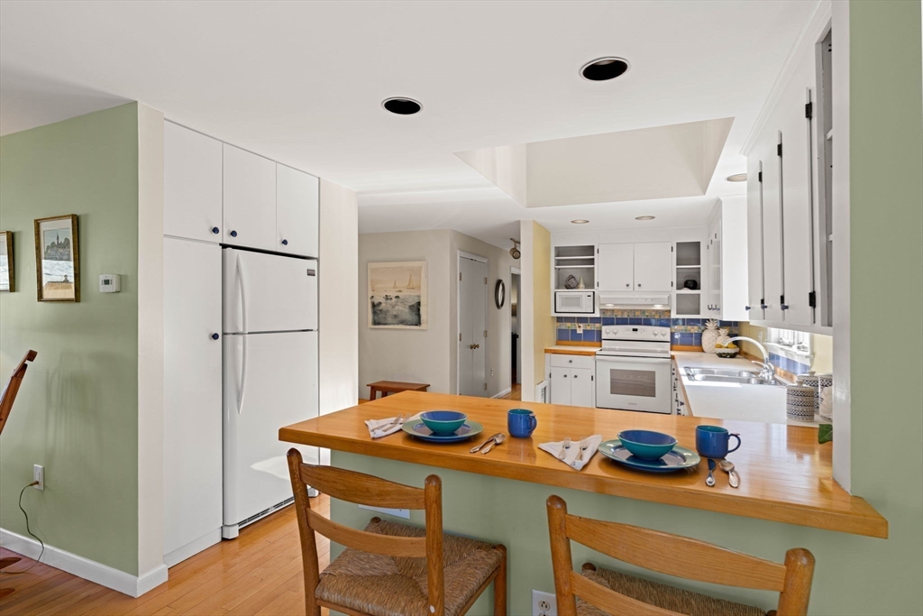153 Jersey Street Marblehead, MA 01945 - Photo 8 of 34 a kitchen with stainless steel appliances kitchen island granite countertop a refrigerator and a stove