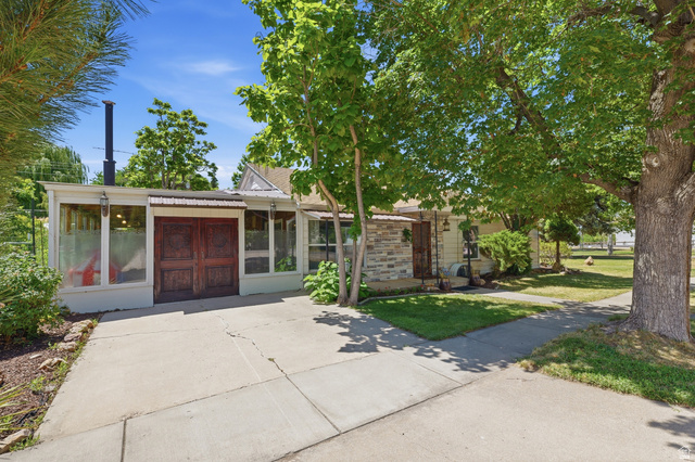 365 North Main Street Fillmore, UT 84631 - Photo 40 of 51 Exterior facade with a concrete driveway, featuring a sunroom addition with large windows and double wooden doors