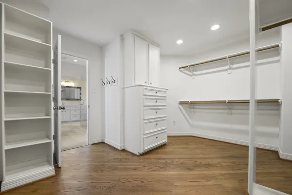 a view of walk in closet with empty racks