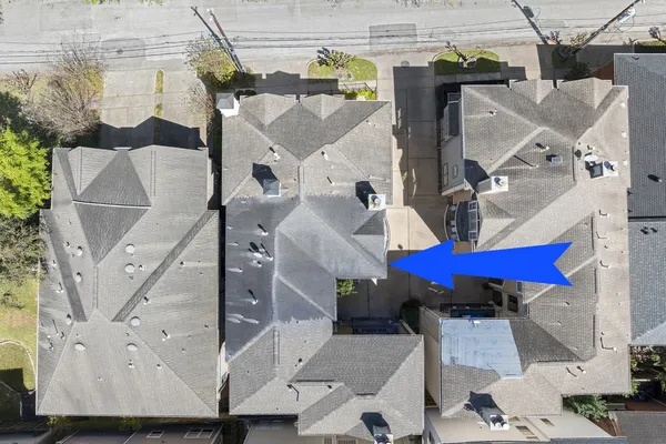 an aerial view of a house with a yard and furniture