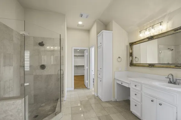 a bathroom with a shower sink and mirror