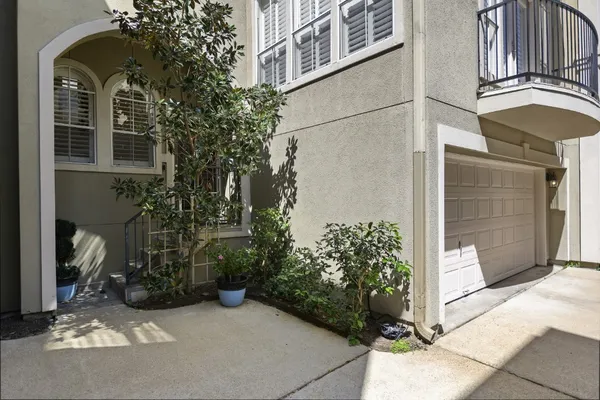 a view of a house with potted plants