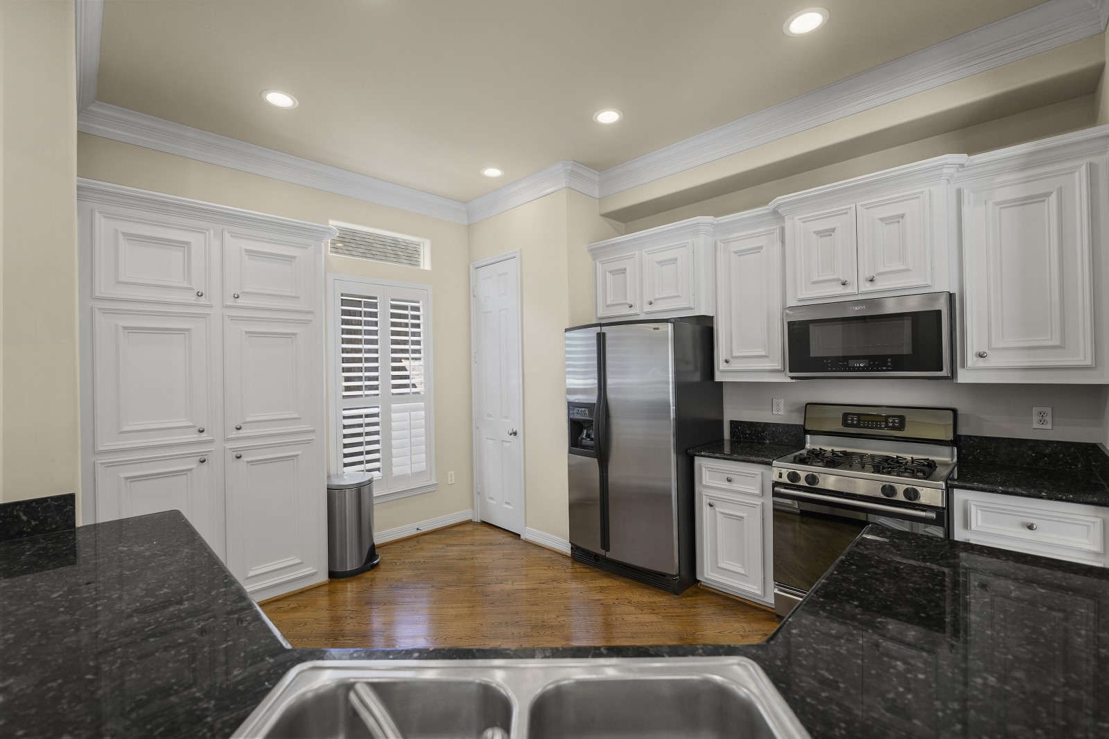 3307 West Lamar Street, Unit B Houston, TX 77019 - Photo 9 of 27 a kitchen with stainless steel appliances granite countertop a refrigerator and a stove top oven