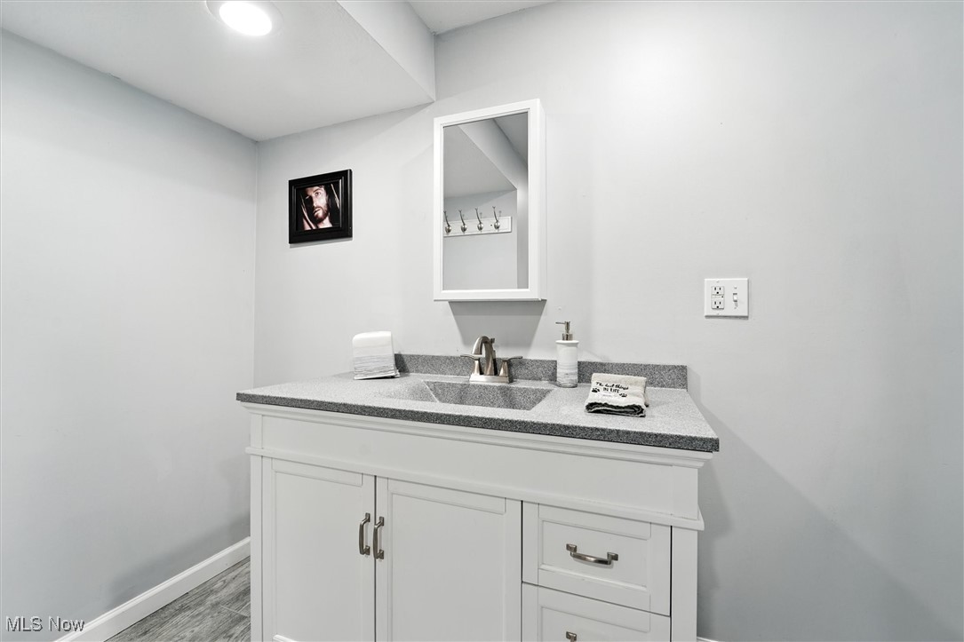 3576 Plymouth Ridge Road Kingsville, OH 44048 - Photo 35 of 43 Bathroom with vanity and dark wood finished floors