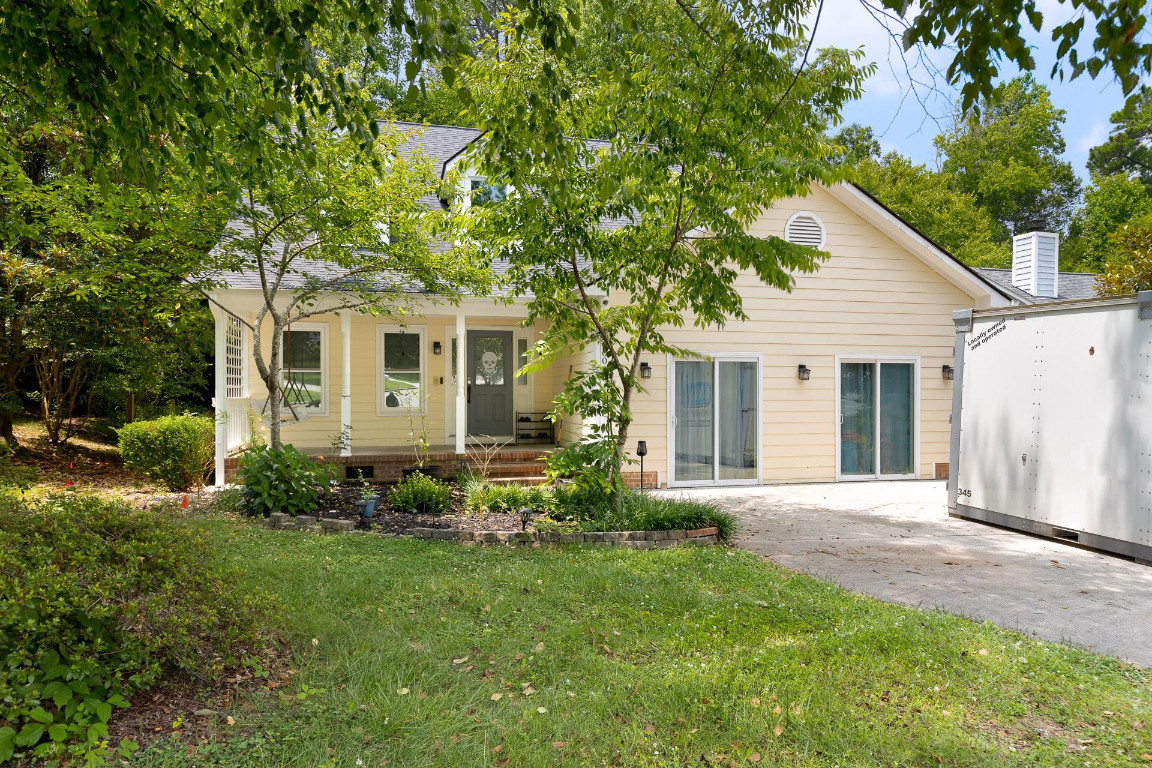 a front view of house with yard and green space