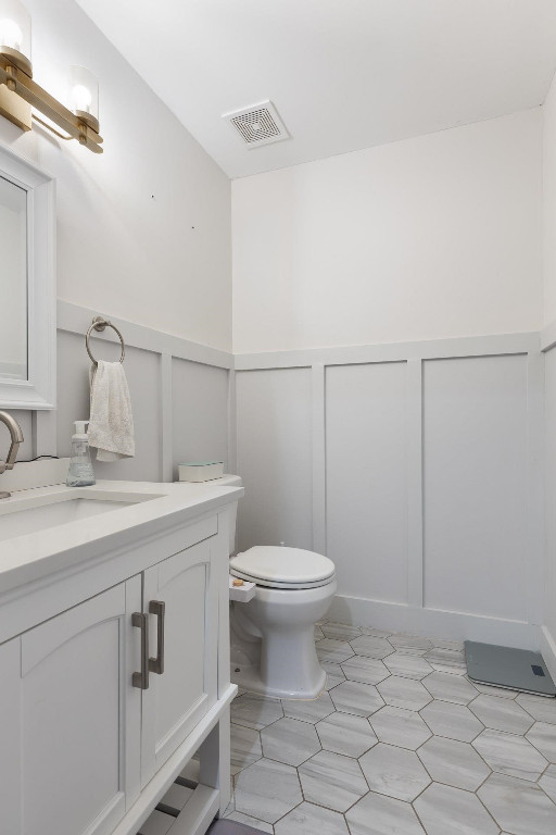 5006 Greenview Drive Durham, NC 27713 - Photo 12 of 34 a bathroom with a sink a toilet and a mirror