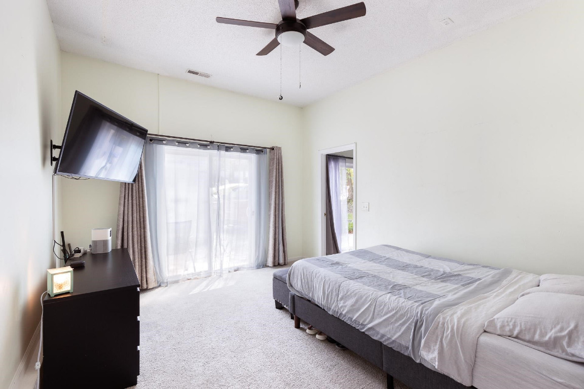 5006 Greenview Drive Durham, NC 27713 - Photo 15 of 34 a bedroom with a bed and a chandelier