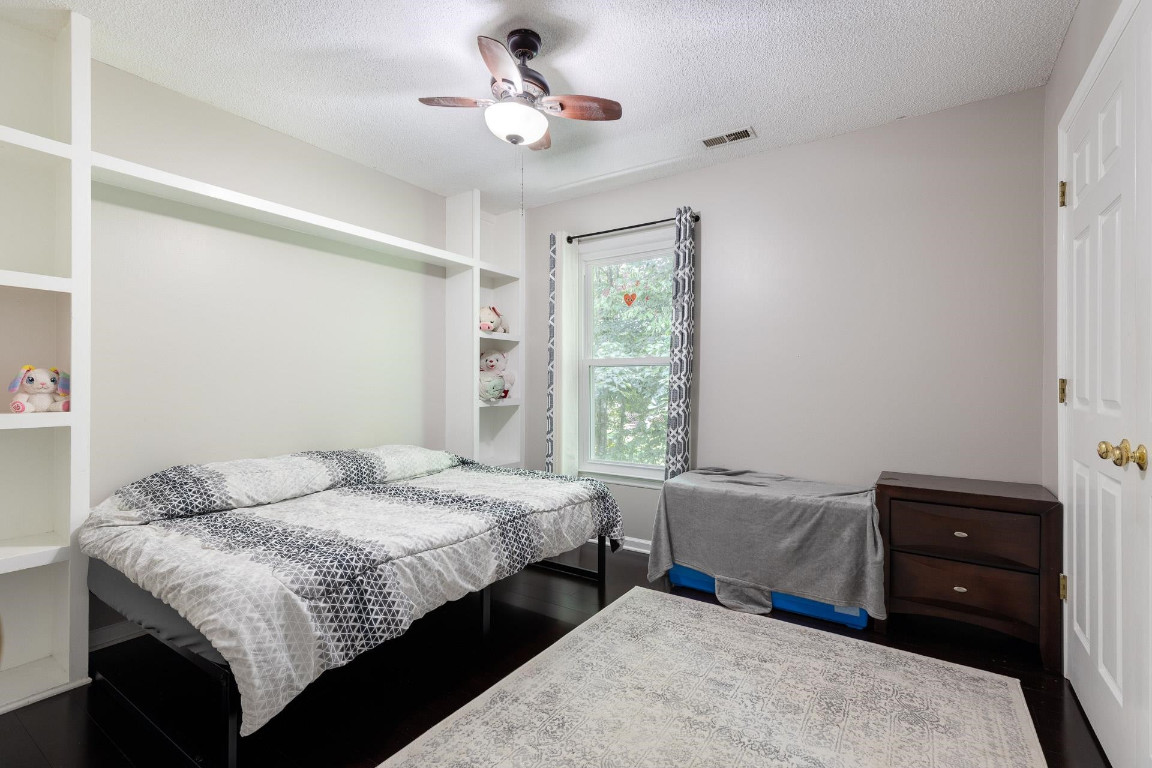 5006 Greenview Drive Durham, NC 27713 - Photo 24 of 34 a bedroom with a bed and wooden floor