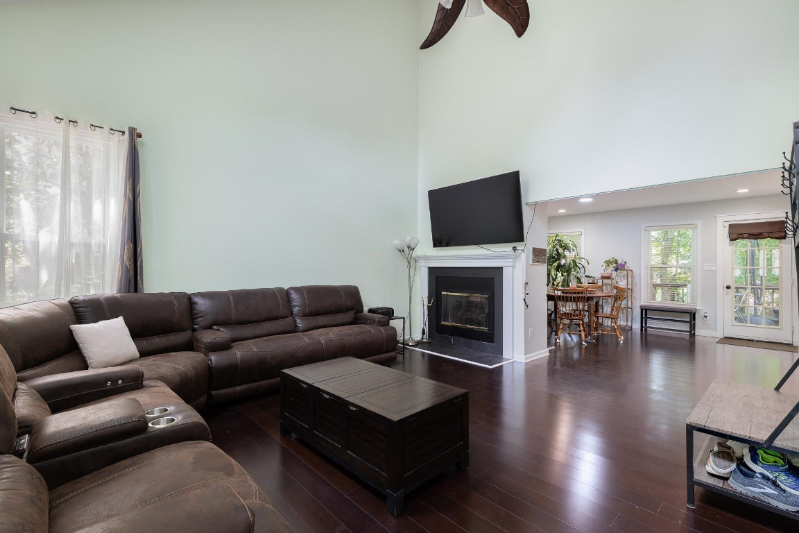 5006 Greenview Drive Durham, NC 27713 - Photo 4 of 34 a living room with furniture a fireplace and a flat screen tv