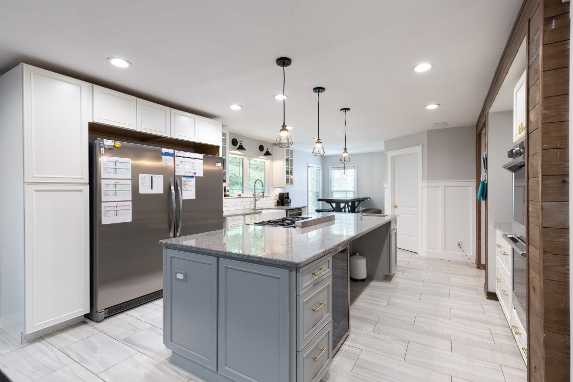5006 Greenview Drive Durham, NC 27713 - Photo 6 of 34 a kitchen with kitchen island granite countertop a sink and refrigerator