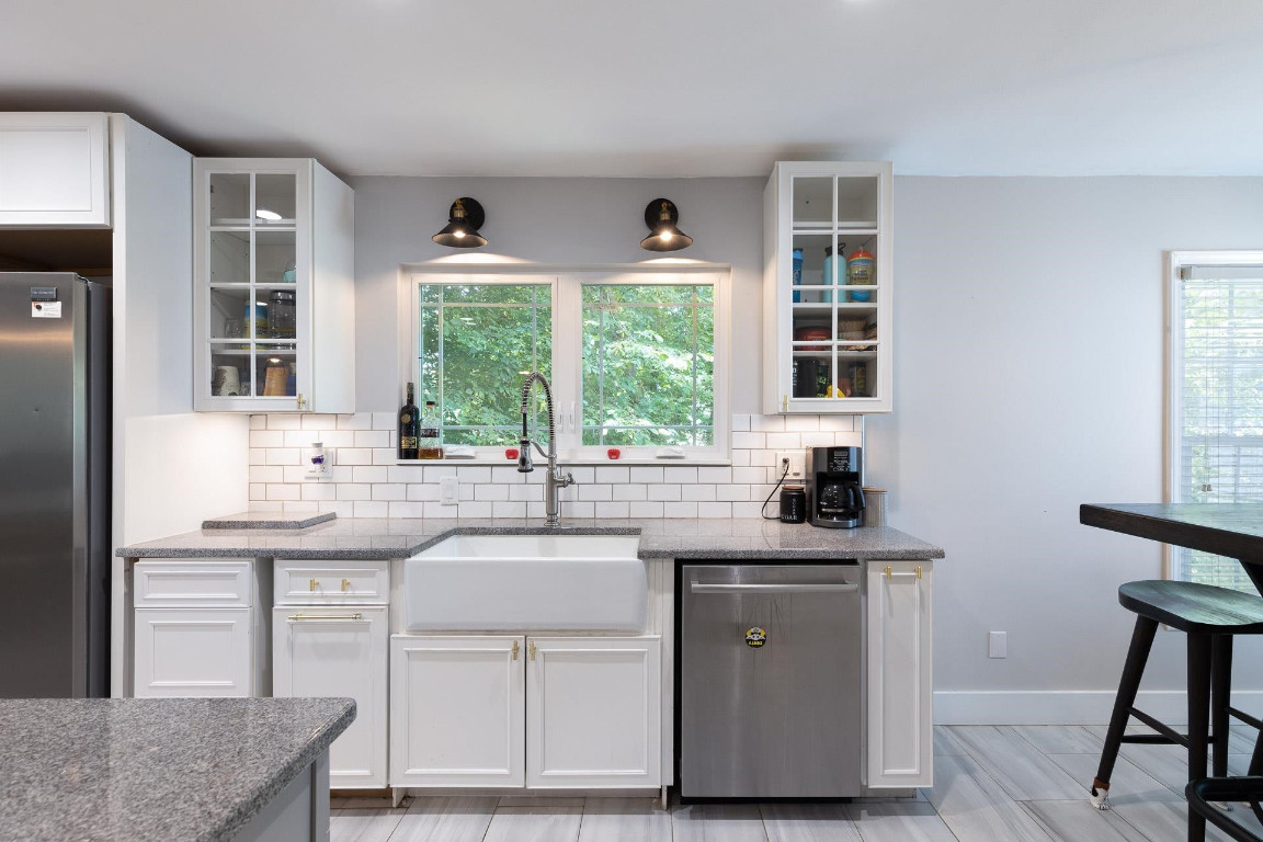 5006 Greenview Drive Durham, NC 27713 - Photo 7 of 34 a kitchen with stainless steel appliances granite countertop a sink stove and cabinets