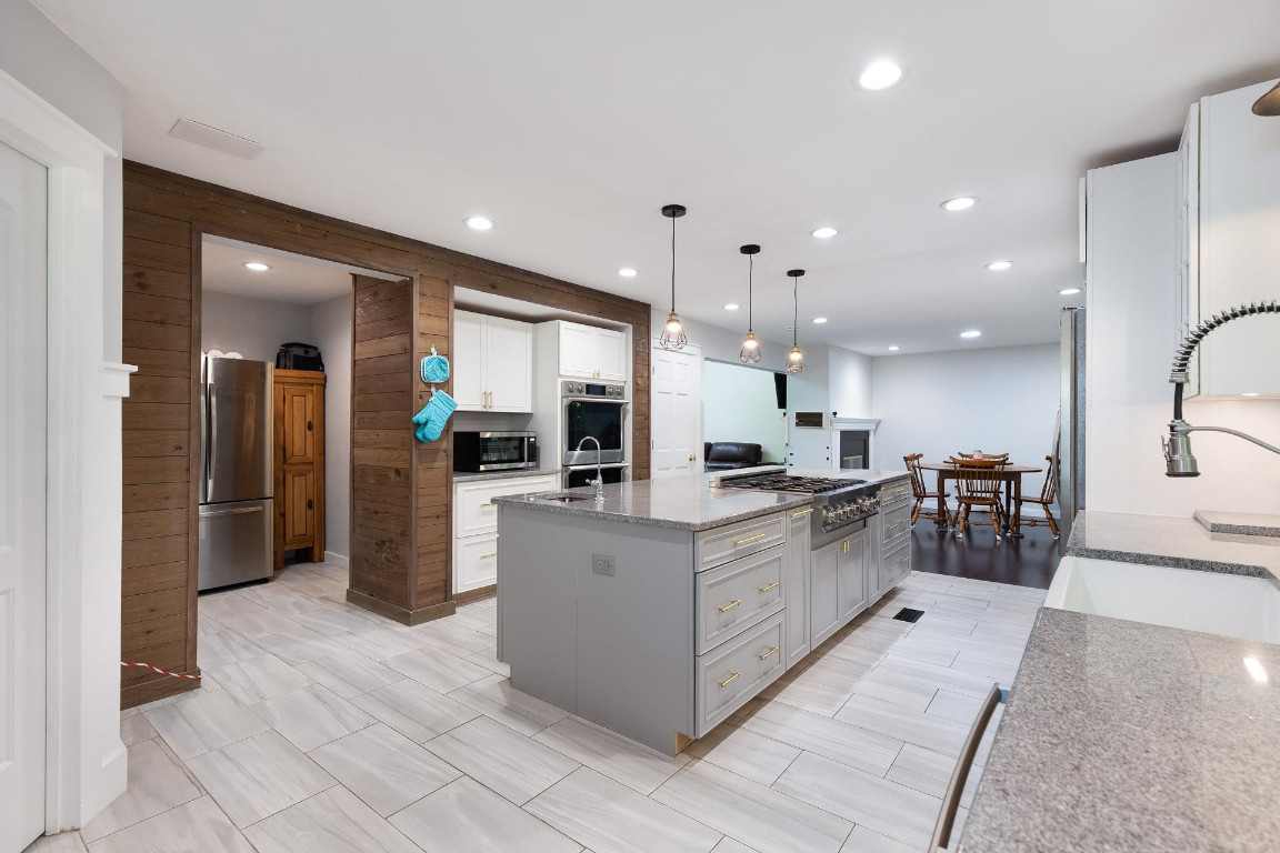 5006 Greenview Drive Durham, NC 27713 - Photo 8 of 34 a large kitchen with stainless steel appliances kitchen island a large counter top and a view of living room