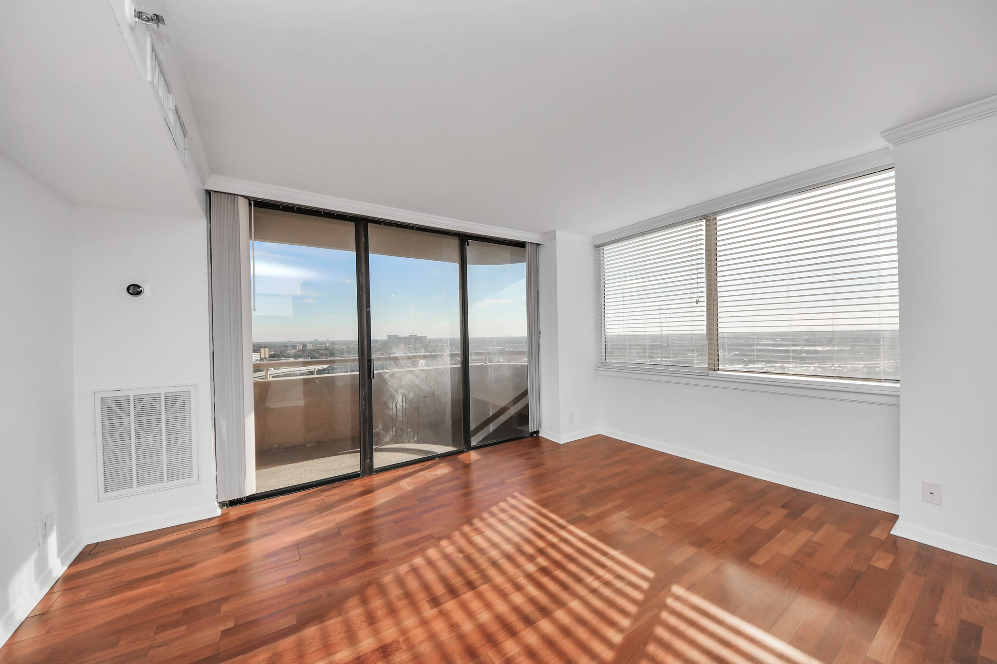 3525 Sage Road, Unit 1503 Houston, TX 77056 - Photo 22 of 50 a view of an empty room with wooden floor and a window