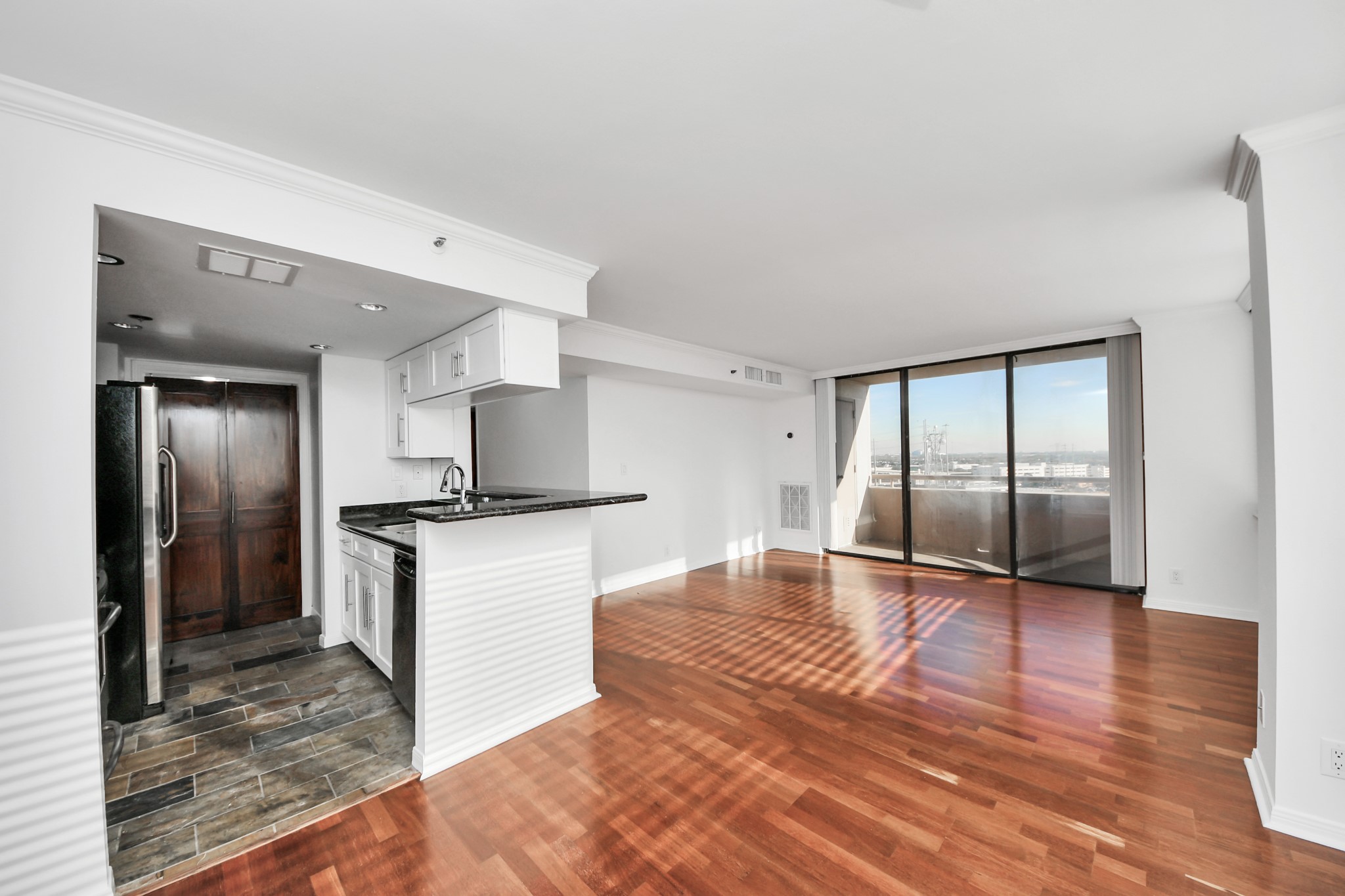 3525 Sage Road, Unit 1503 Houston, TX 77056 - Photo 29 of 50 a large kitchen with stainless steel appliances kitchen island granite countertop a refrigerator and a stove