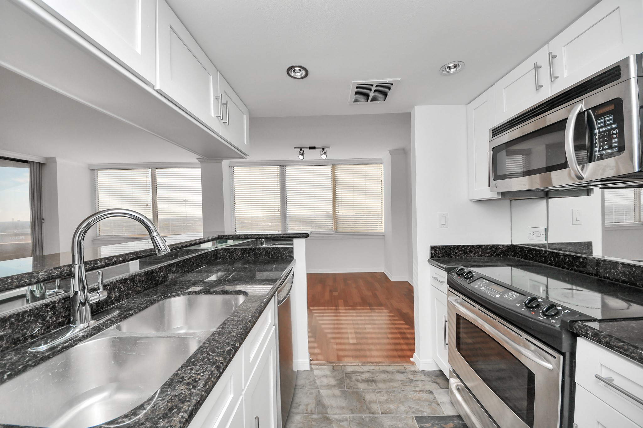 3525 Sage Road, Unit 1503 Houston, TX 77056 - Photo 32 of 50 a kitchen with stainless steel appliances granite countertop a sink stove and cabinets