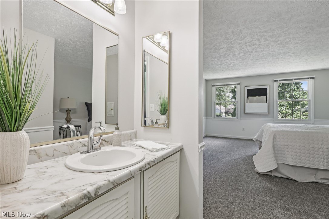 10253 Hoose Road Mentor, OH 44060 - Photo 15 of 30 Bathroom with vanity and a textured ceiling